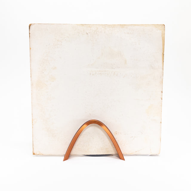 a white square with a wooden curved handle