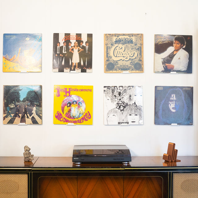 a record player sitting on top of a wooden cabinet
