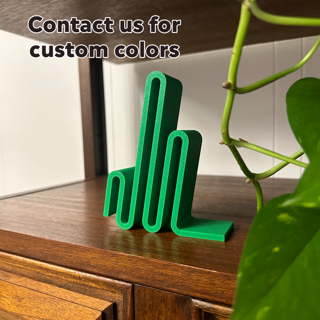 a green object sitting on top of a wooden table