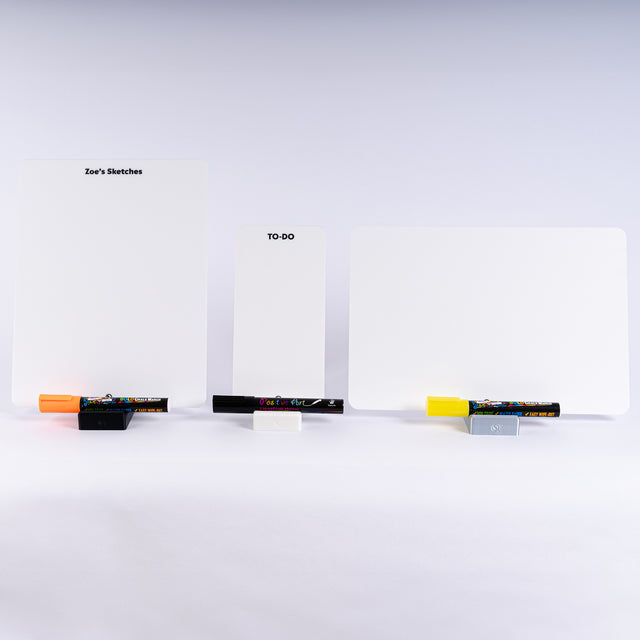 a white table topped with three blank cards