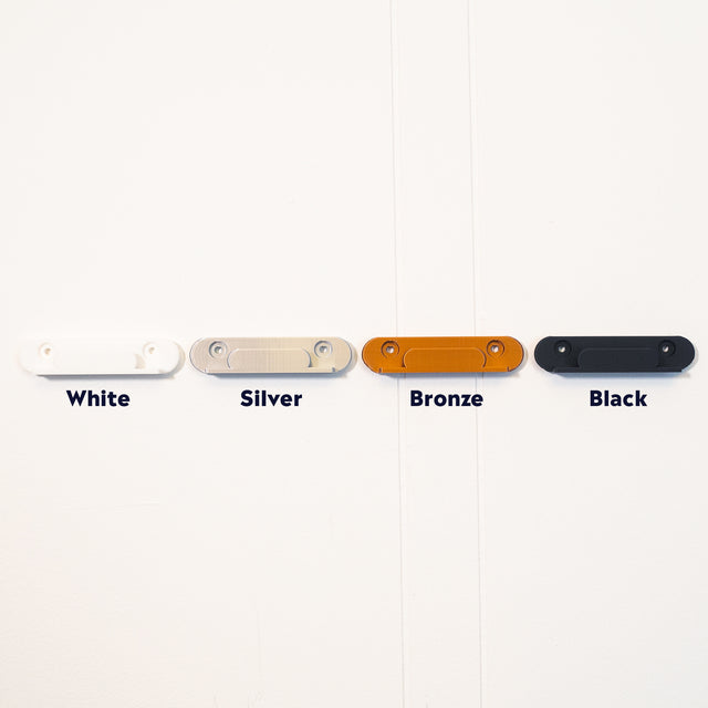 a group of different colored skateboards hanging on a wall