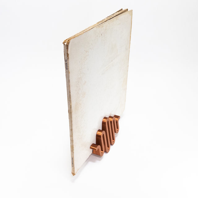 a book with a wooden bookmark on top of it