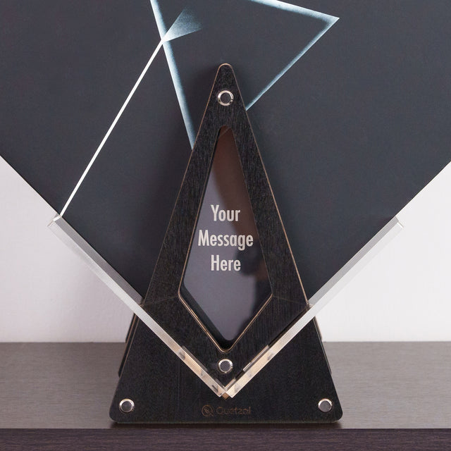 a triangle shaped award with a black base