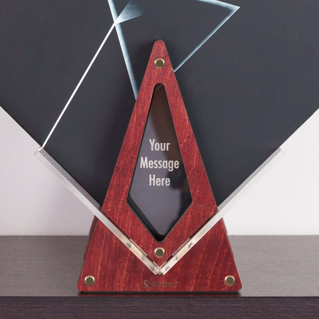 a red triangle shaped award with a black background
