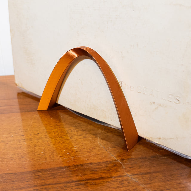 a close up of a curved object on a wooden floor