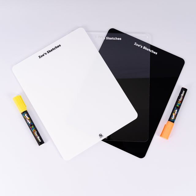 a couple of black and white notebooks next to a yellow marker