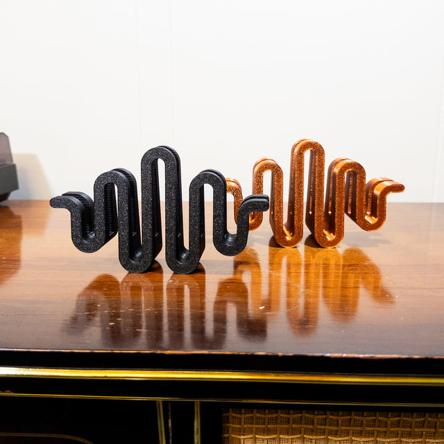 a wooden table topped with metal letters on top of it