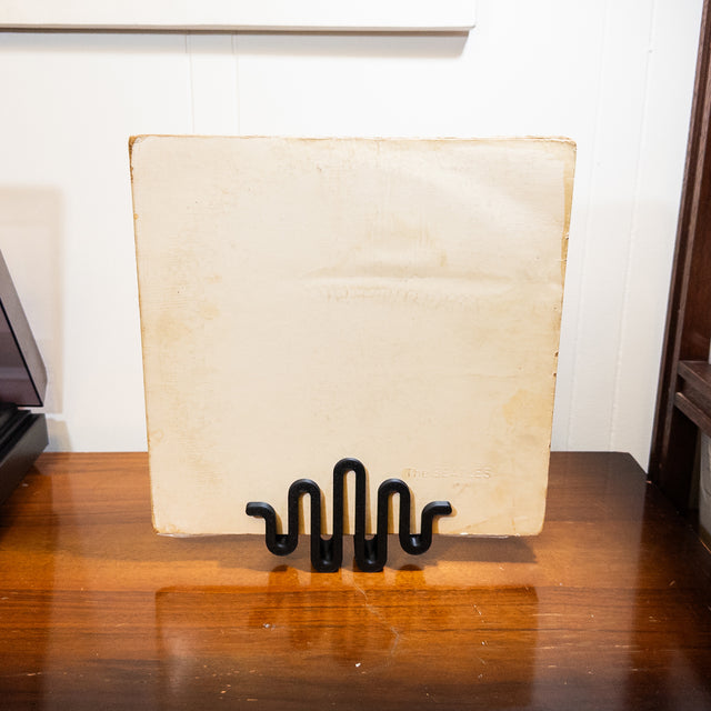 a wooden table with a couple of black objects on top of it