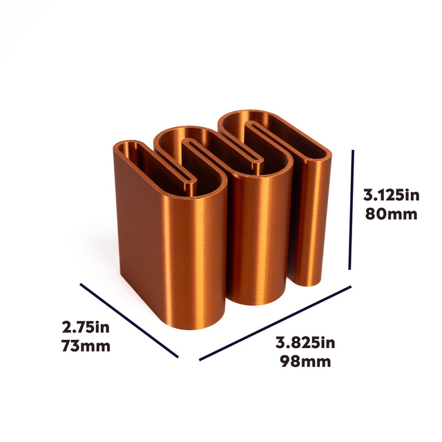 a set of three copper metal tubes on a white background